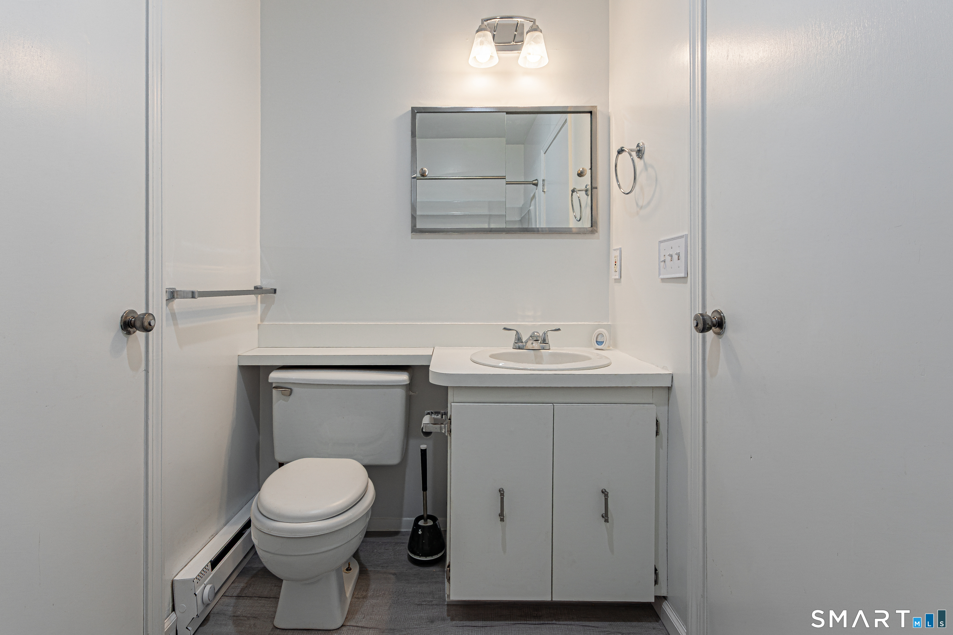 127 Old Farms Road, Unit 127 Torrington, CT 06790 - Photo 31 of 32 a bathroom with a toilet sink and mirror