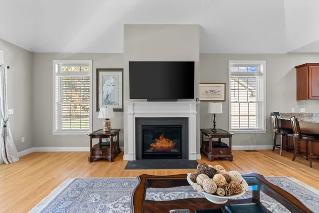 a living room with furniture fireplace and window