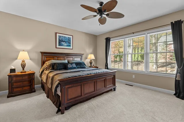 a bedroom with a large bed and a large window