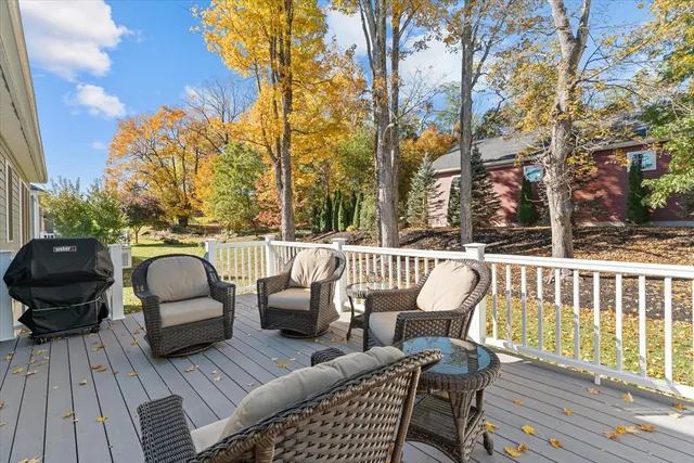 a roof deck with couches and wooden floor