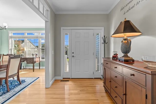 a kitchen with cabinets and wooden floor