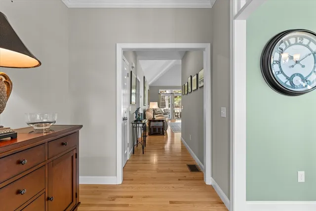 a view of a hallway to a livingroom with furniture