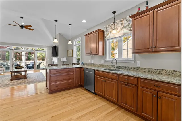 a large kitchen with granite countertop a lot of counter space and wooden floor