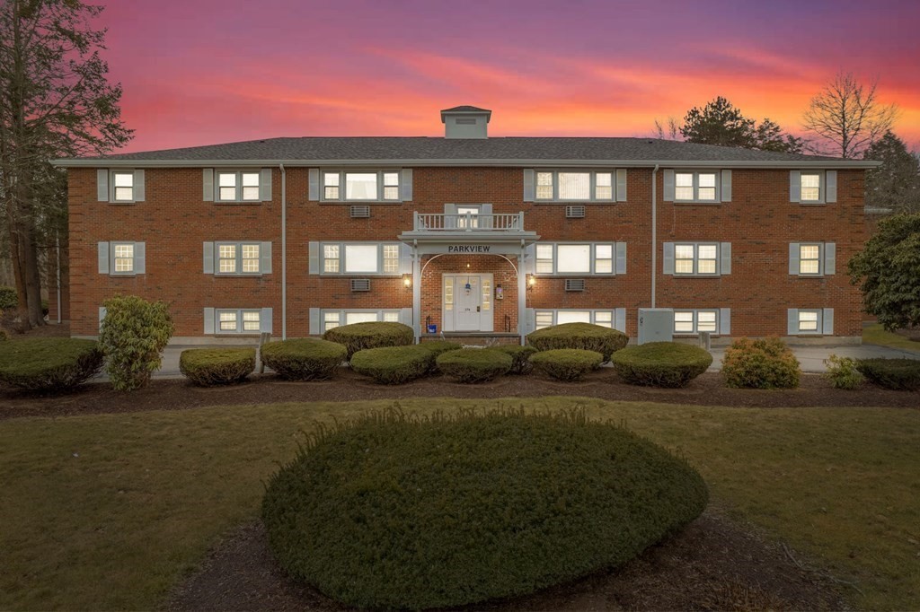 a front view of building with yard and green space