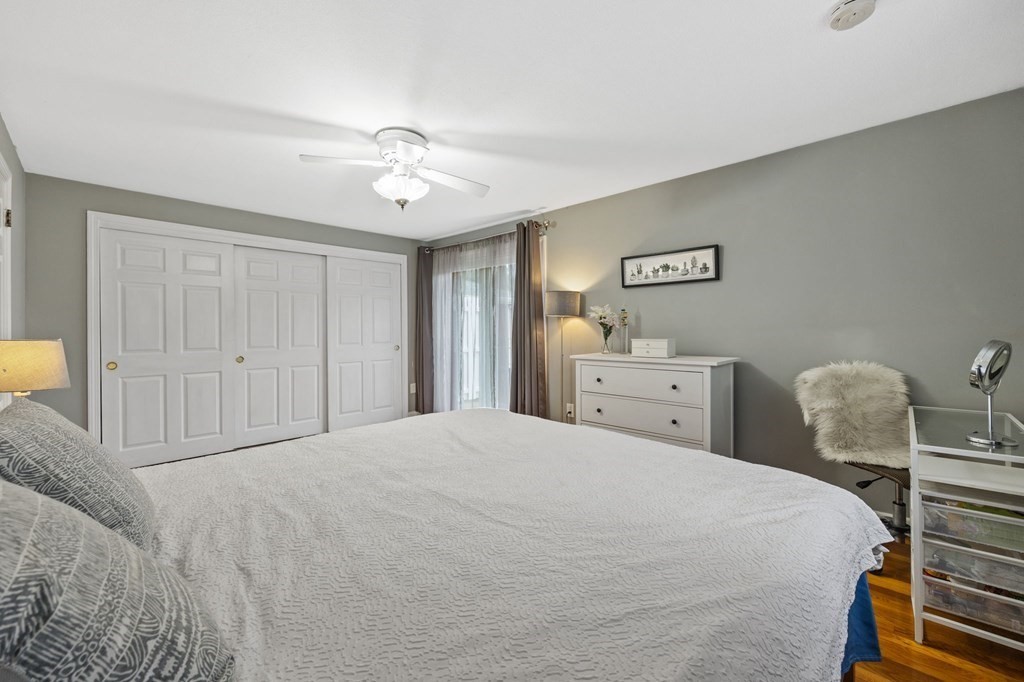 224 School Street, Unit 10 Walpole, MA 02081 - Photo 13 of 41 a spacious bedroom with a bed and a chandelier