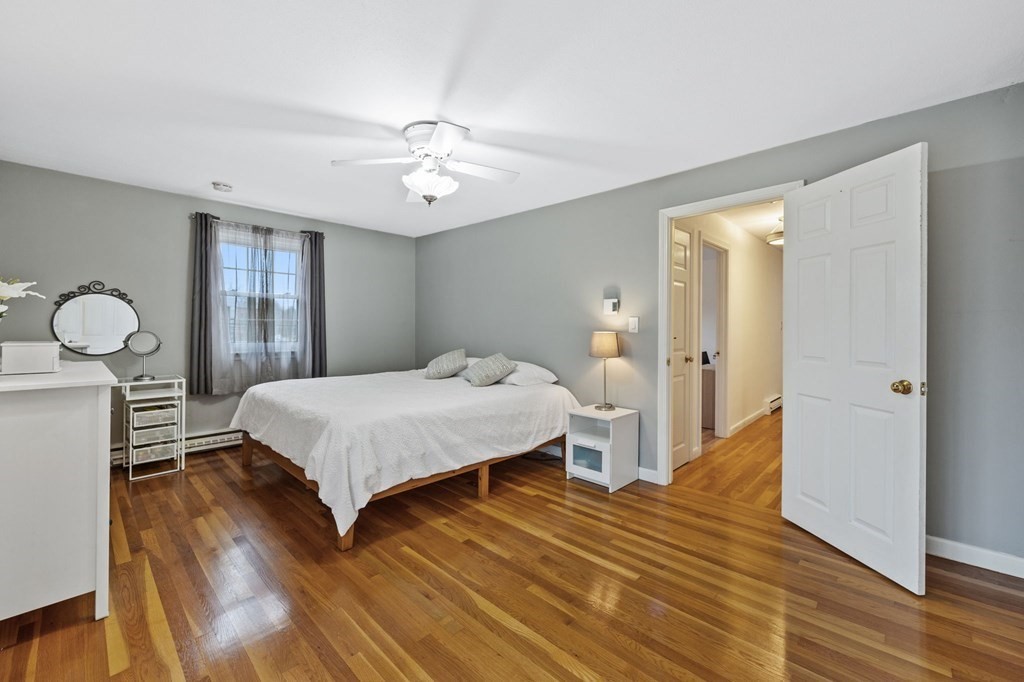224 School Street, Unit 10 Walpole, MA 02081 - Photo 14 of 41 a bedroom with a bed and wooden floor