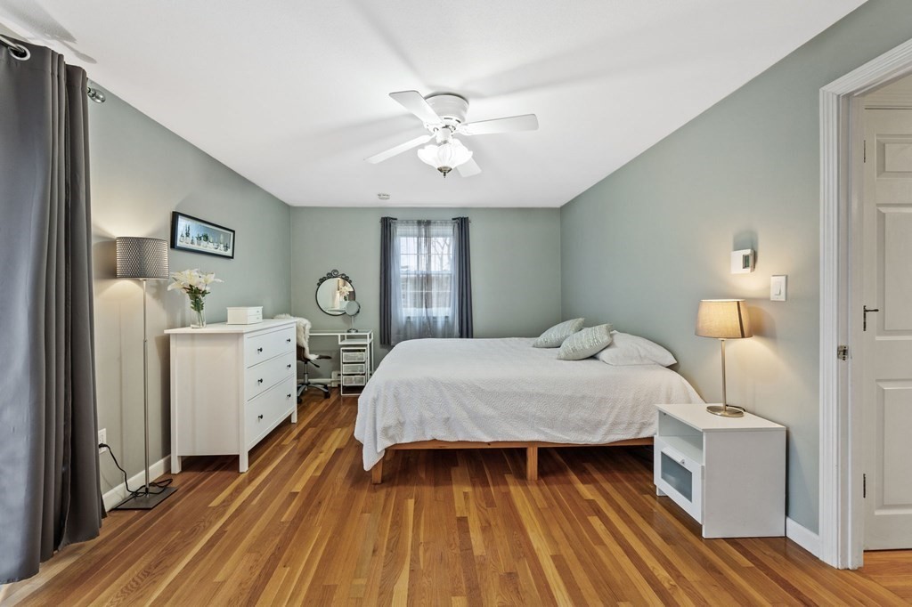 224 School Street, Unit 10 Walpole, MA 02081 - Photo 15 of 41 a bed room with a bed and a chandelier