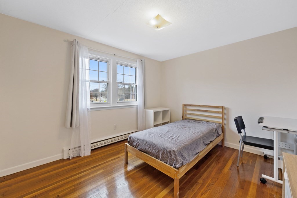 224 School Street, Unit 10 Walpole, MA 02081 - Photo 17 of 41 a room with a bed and a window