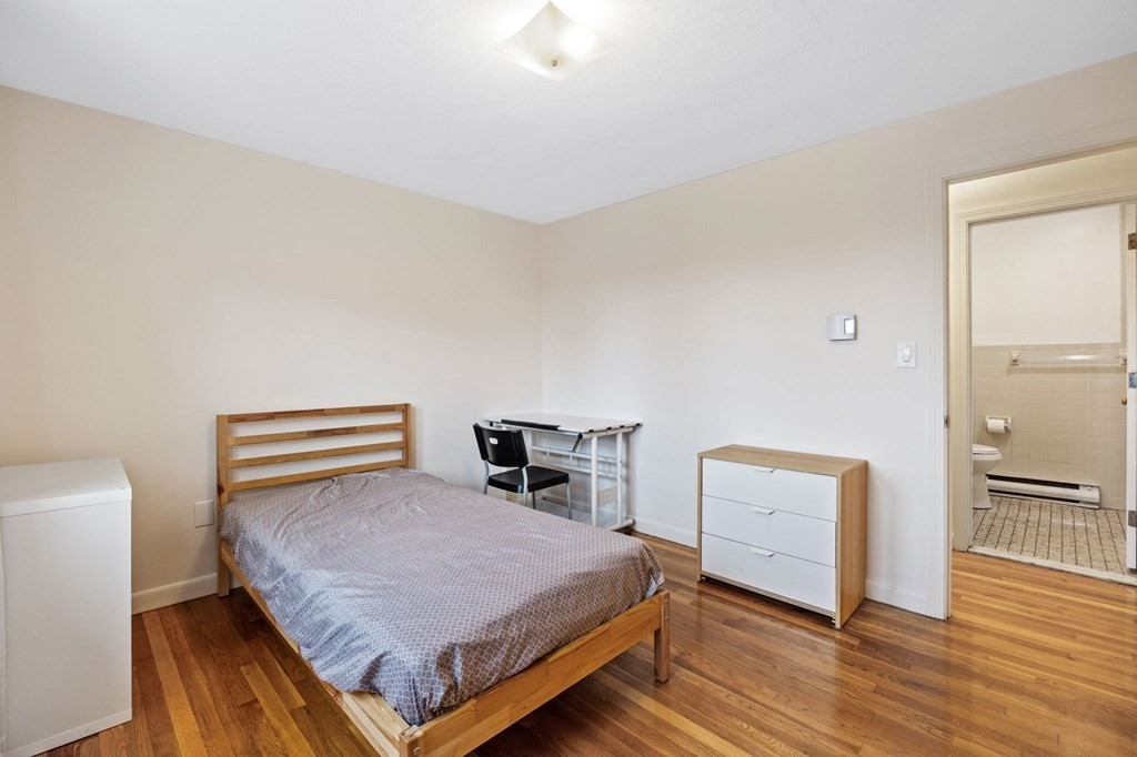224 School Street, Unit 10 Walpole, MA 02081 - Photo 18 of 41 a bedroom with a bed and wooden floor