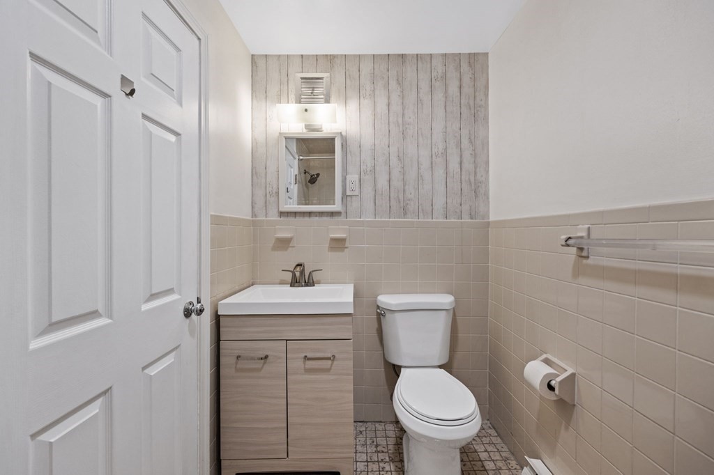 224 School Street, Unit 10 Walpole, MA 02081 - Photo 20 of 41 a white toilet sitting next to a bathroom sink