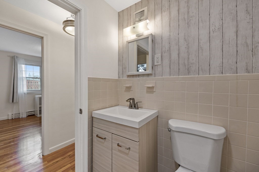 224 School Street, Unit 10 Walpole, MA 02081 - Photo 21 of 41 a bathroom with a toilet sink and mirror