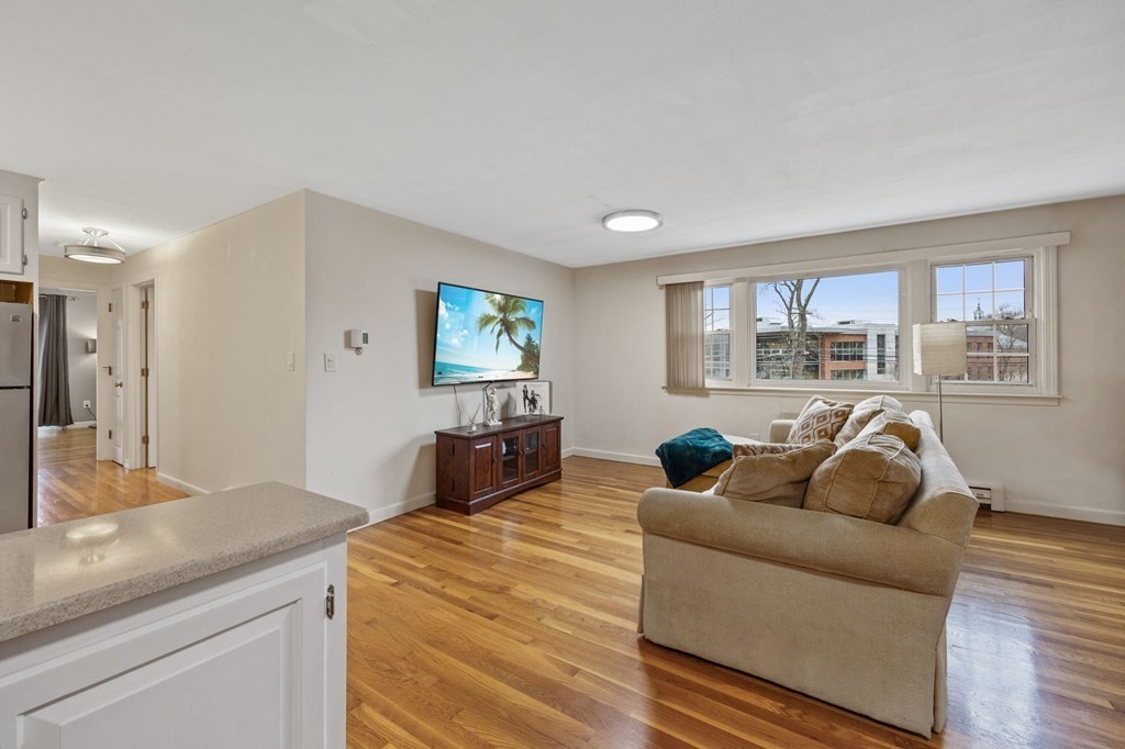 224 School Street, Unit 10 Walpole, MA 02081 - Photo 5 of 41 a living room with furniture and a flat screen tv