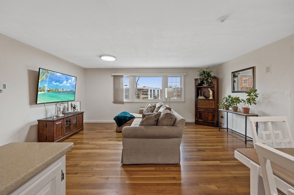 224 School Street, Unit 10 Walpole, MA 02081 - Photo 6 of 41 a living room with furniture and a flat screen tv