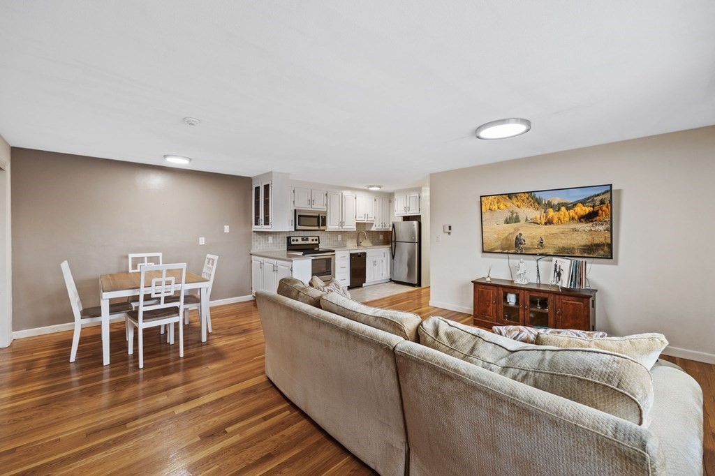 224 School Street, Unit 10 Walpole, MA 02081 - Photo 9 of 41 a living room with furniture and a wooden floor