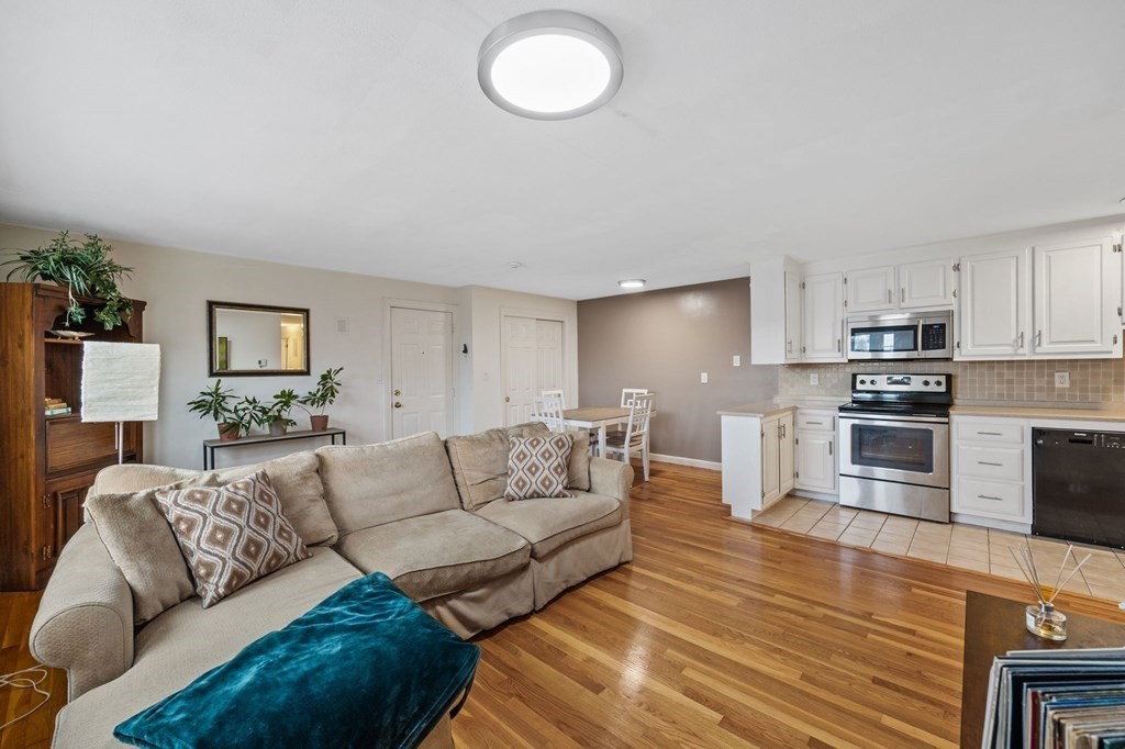 224 School Street, Unit 10 Walpole, MA 02081 - Photo 10 of 41 a living room with furniture and a wooden floor