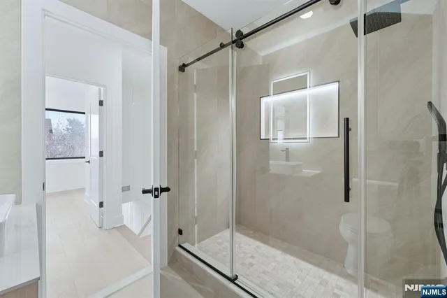 a bathroom with a glass shower door