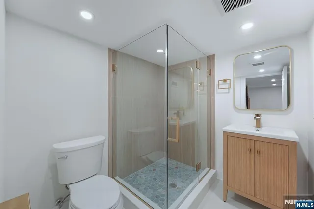 a bathroom with a shower a toilet and sink