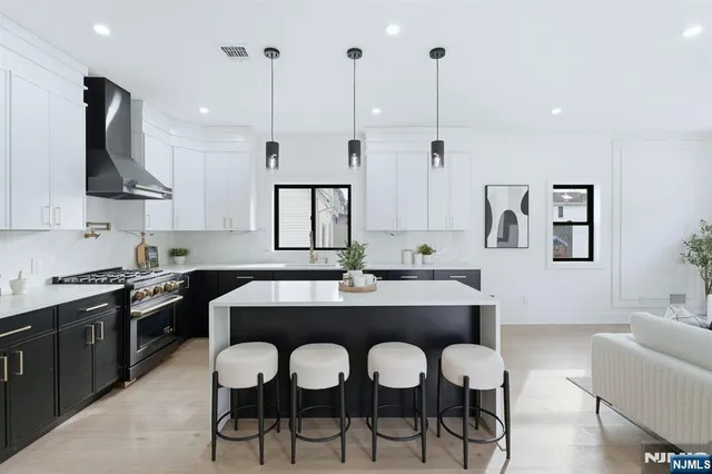 a large kitchen with a table and chairs