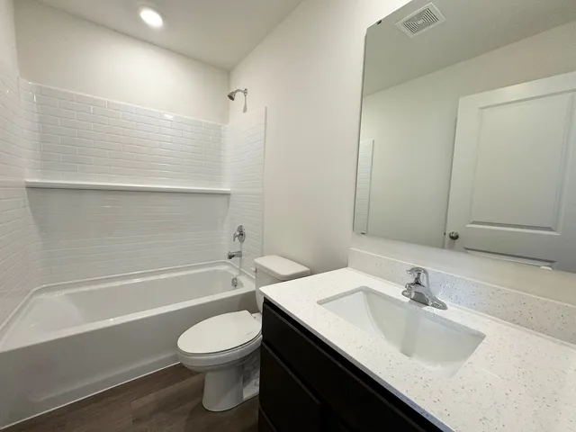 a bathroom with a sink a toilet and a bathtub