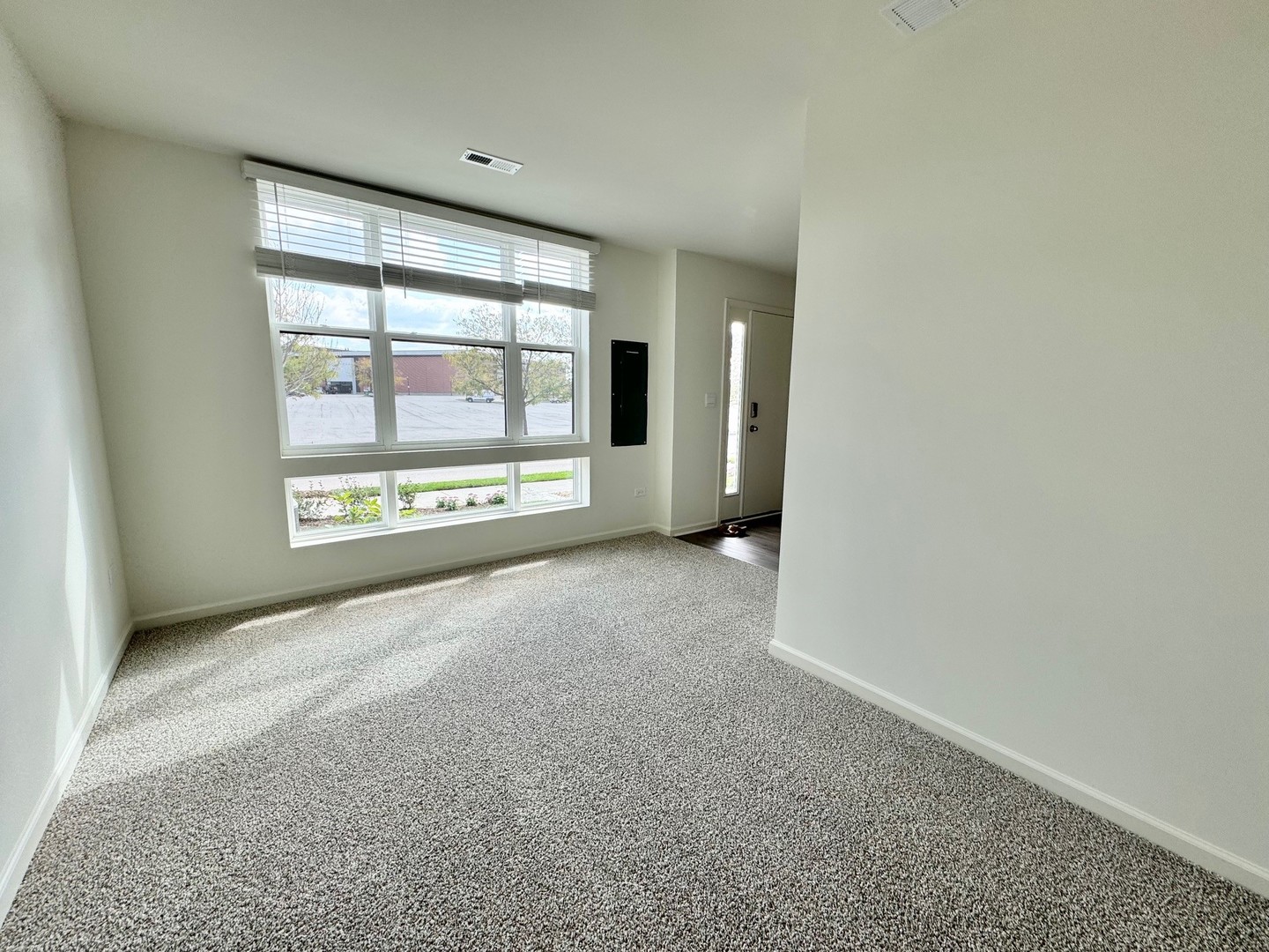 387 Summit Circle Lombard, IL 60148 - Photo 12 of 48 an empty room with a fireplace and windows