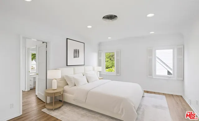 a spacious bedroom with a bed and a couch