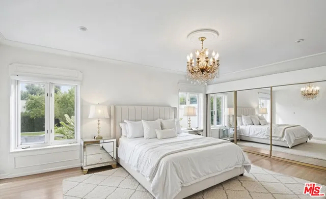 a bedroom with a balcony bed and a chandelier