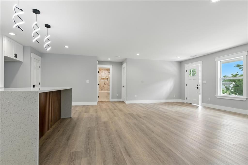 194 Harris Loop Dallas, GA 30157 - Photo 14 of 25 a view of an empty room with wooden floor and a window