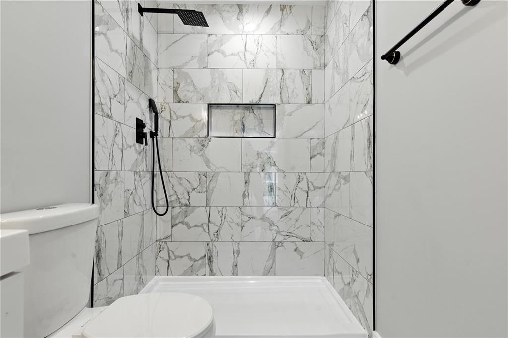 194 Harris Loop Dallas, GA 30157 - Photo 18 of 25 a bathroom with a toilet and shower