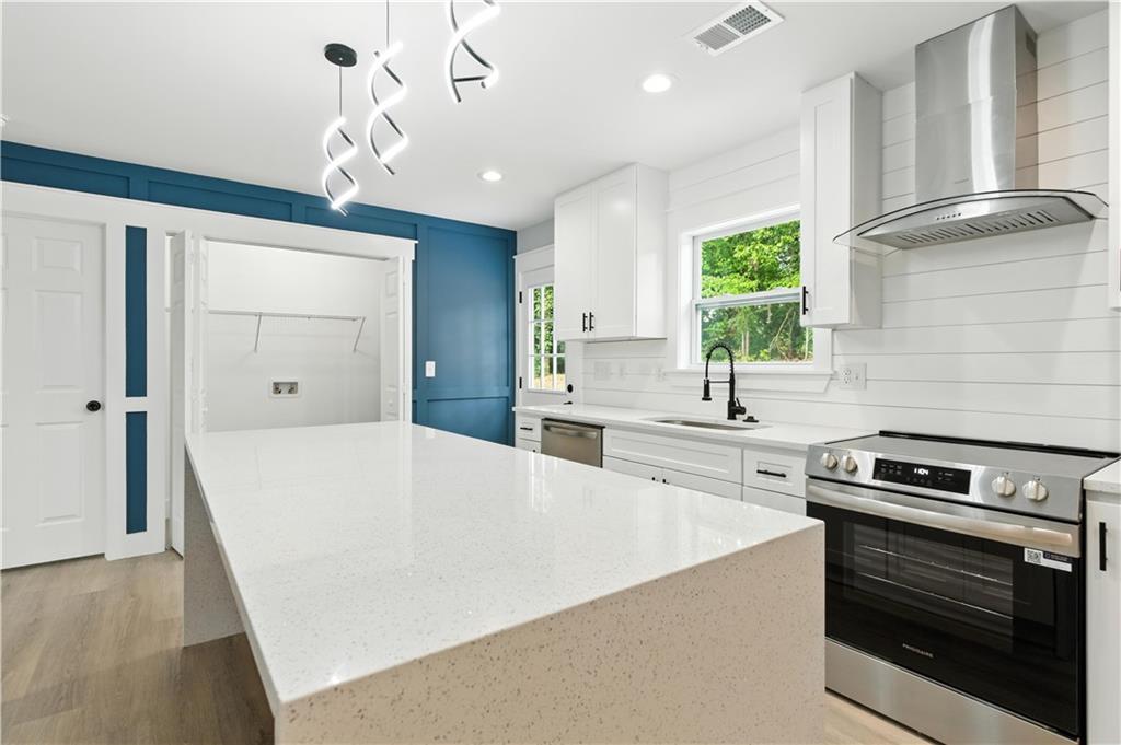 194 Harris Loop Dallas, GA 30157 - Photo 7 of 25 a large kitchen with stainless steel appliances a large counter top