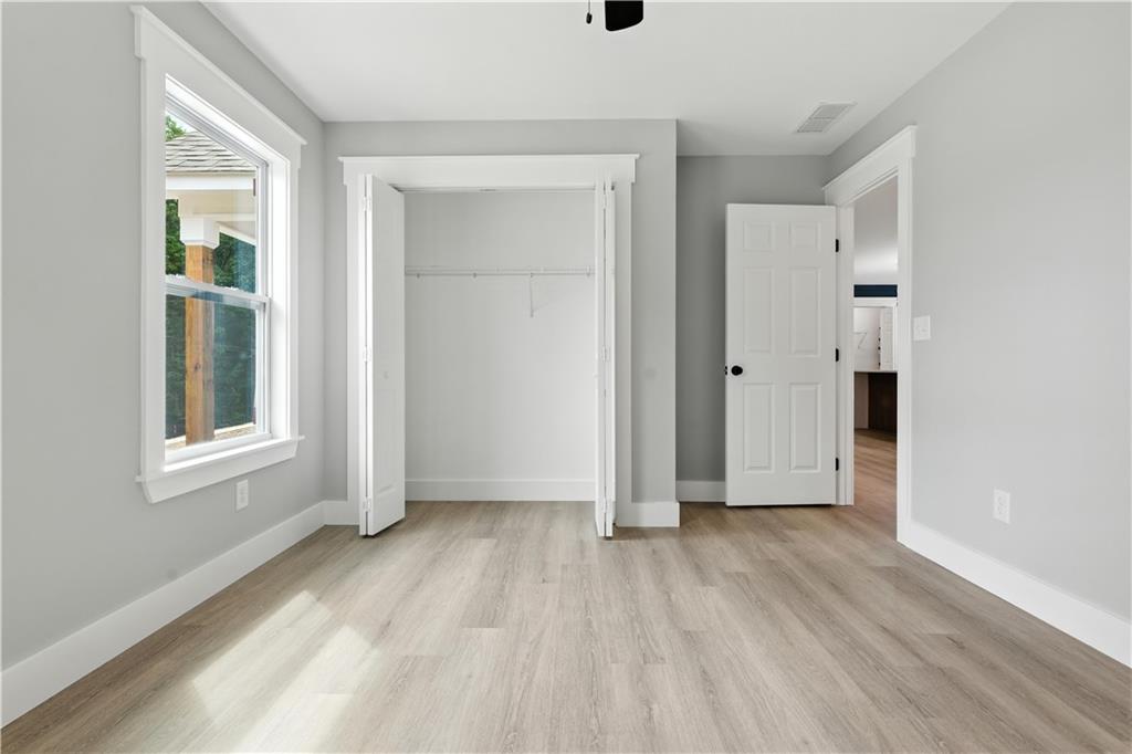 194 Harris Loop Dallas, GA 30157 - Photo 9 of 25 an empty room with wooden floor and windows