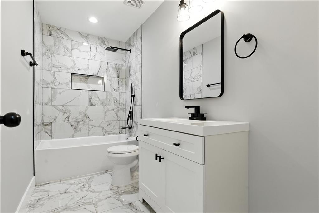 194 Harris Loop Dallas, GA 30157 - Photo 10 of 25 a bathroom with a sink a toilet and shower