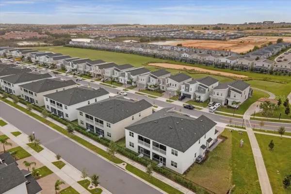 an aerial view of residential building with outdoor space and ocean view