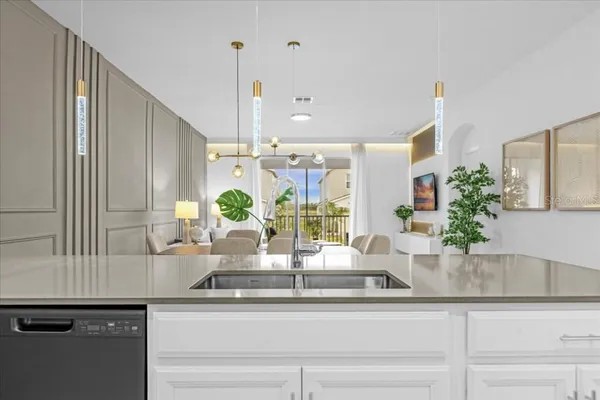 a view of a kitchen with kitchen island and stainless steel appliances