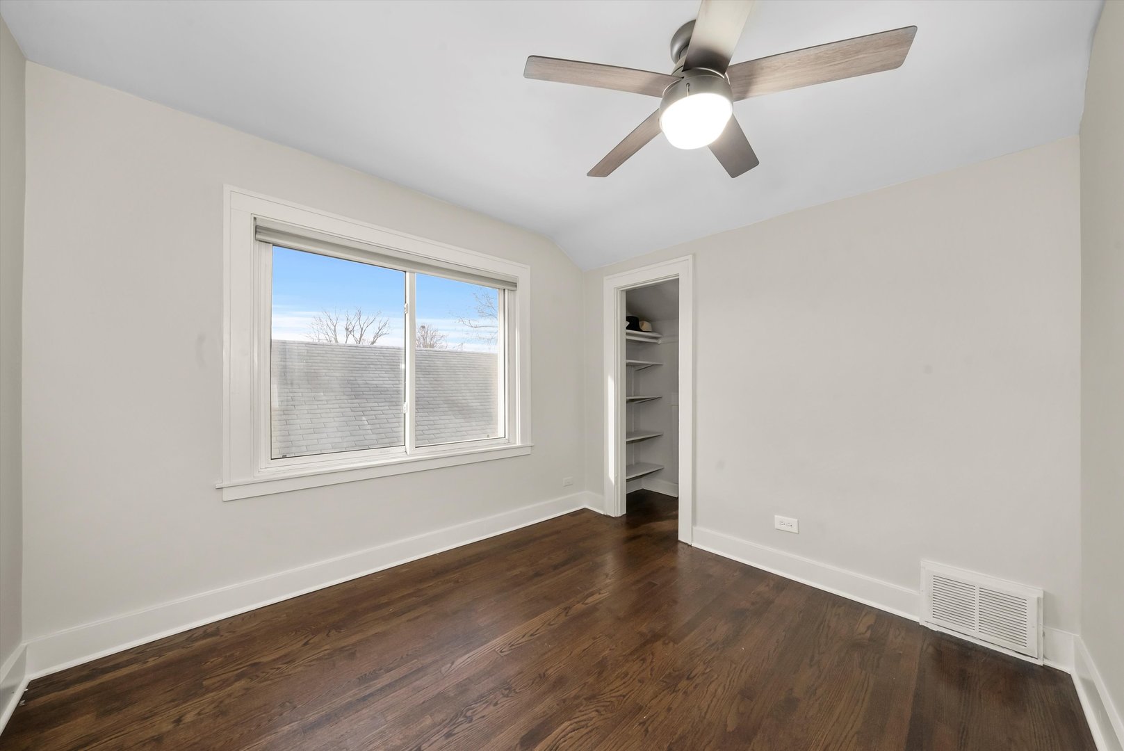 6514 Sinclair Avenue Berwyn, IL 60402 - Photo 18 of 33 an empty room with wooden floor chandelier fan and windows