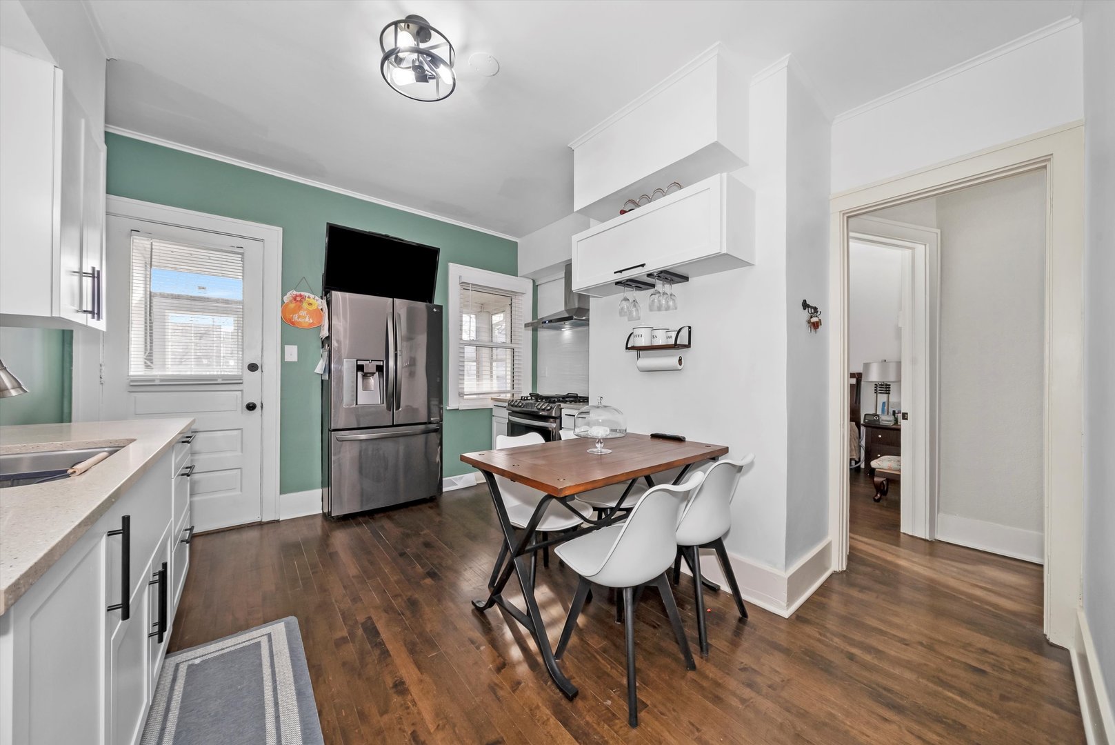 6514 Sinclair Avenue Berwyn, IL 60402 - Photo 7 of 33 a kitchen with stainless steel appliances a dining table chairs and refrigerator