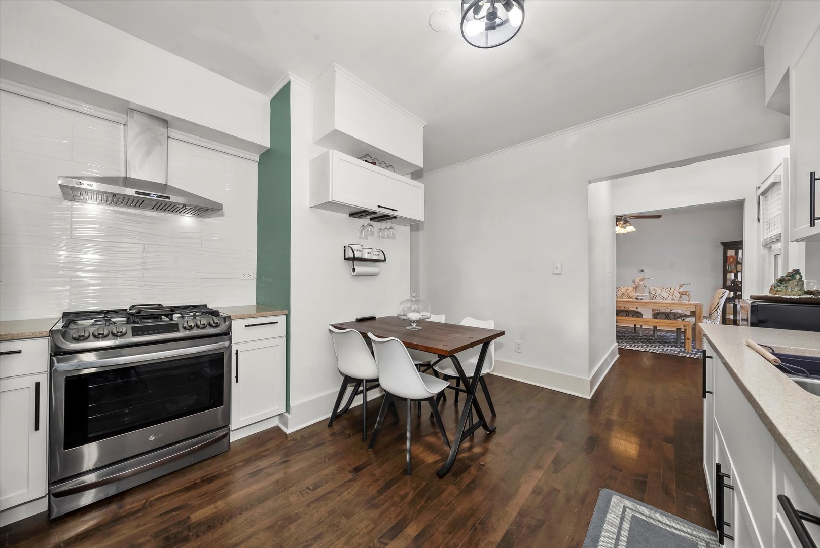 6514 Sinclair Avenue Berwyn, IL 60402 - Photo 8 of 33 a kitchen with stainless steel appliances a stove a table and chairs