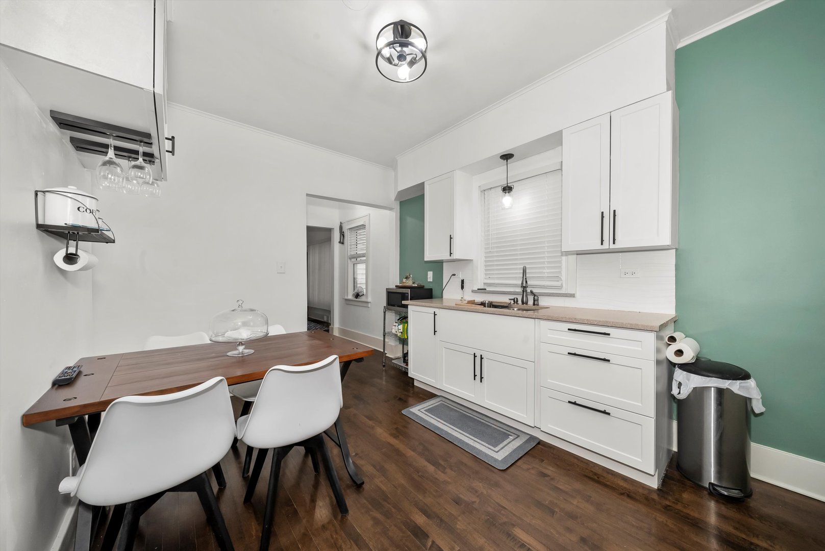 6514 Sinclair Avenue Berwyn, IL 60402 - Photo 9 of 33 a kitchen with a table chairs sink and cabinets