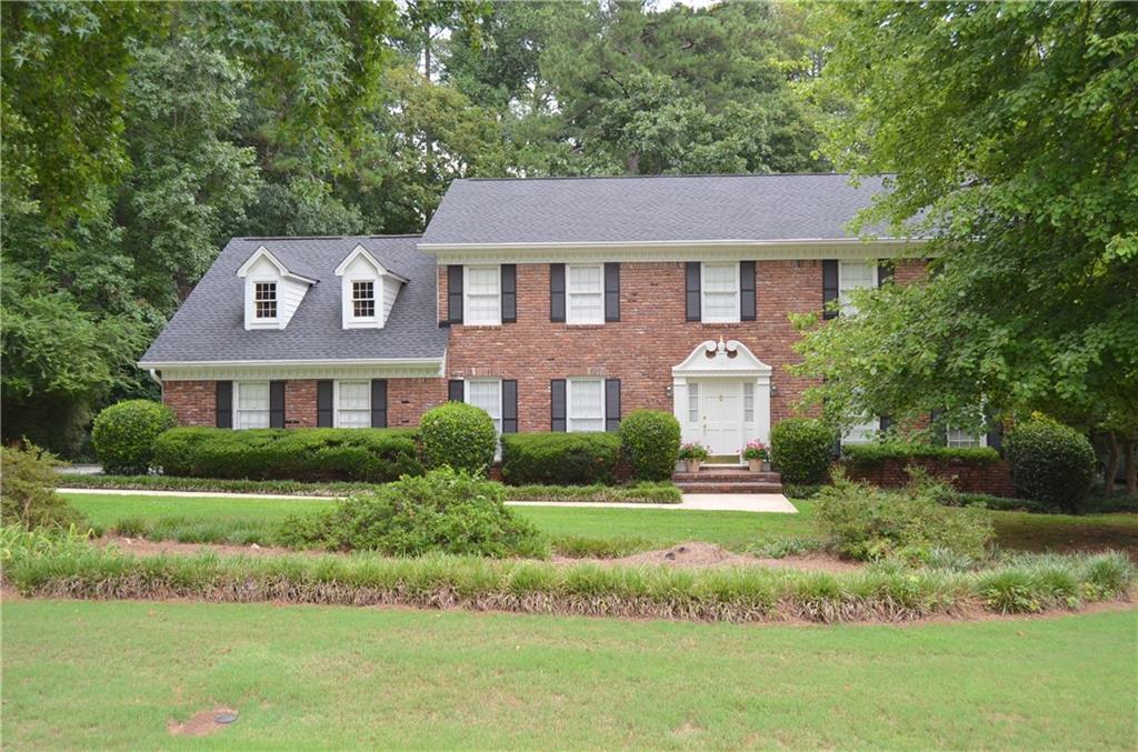 2185 Forestglade Drive Smoke Rise, GA 30087 - Photo 1 of 1 a front view of a house with a yard
