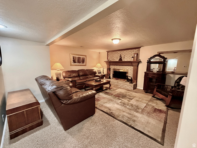 12080 Mill Ridge Circle Sandy, UT 84094 - Photo 29 of 56 Carpeted living area featuring a brick fireplace with a wood mantel