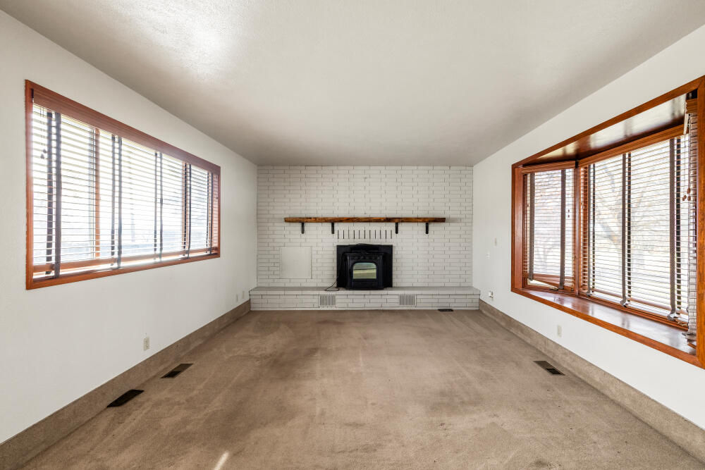 23131 North Poe Valley Road Klamath Falls, OR 97603 - Photo 10 of 45 a view of an empty room with a window and fireplace
