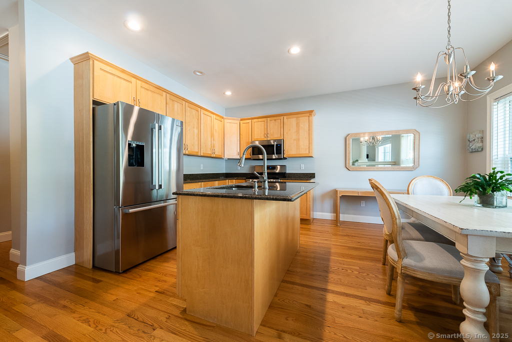 175 Ferry Road, Unit 3 Old Saybrook, CT 06475 - Photo 11 of 37 a kitchen with stainless steel appliances granite countertop a refrigerator a oven a sink with island and chairs