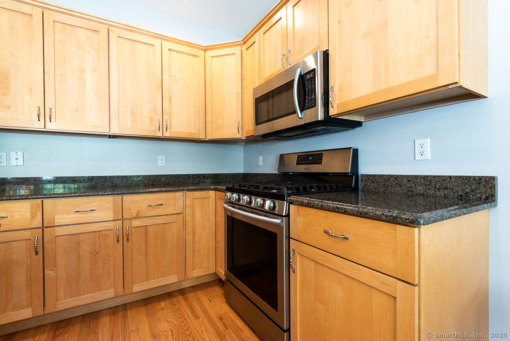 175 Ferry Road, Unit 3 Old Saybrook, CT 06475 - Photo 13 of 37 a kitchen with stainless steel appliances granite countertop a stove a sink and a microwave