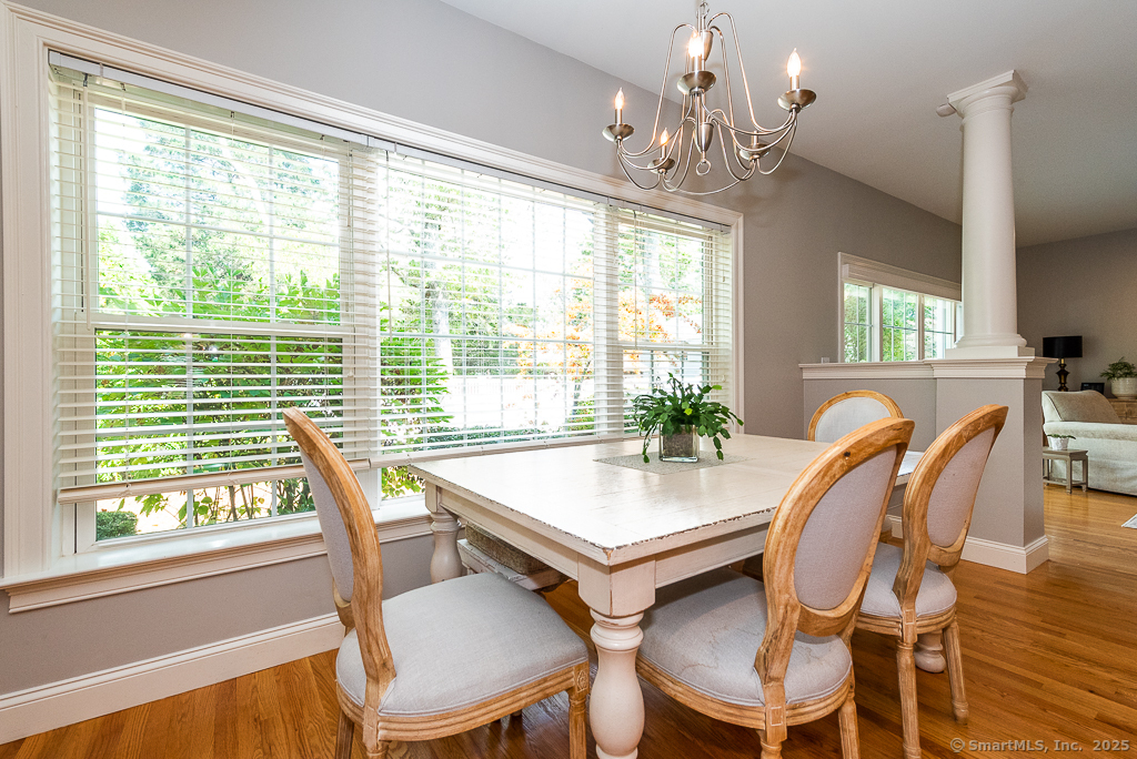 175 Ferry Road, Unit 3 Old Saybrook, CT 06475 - Photo 15 of 37 a view of a dining room with furniture a chandelier and wooden floor