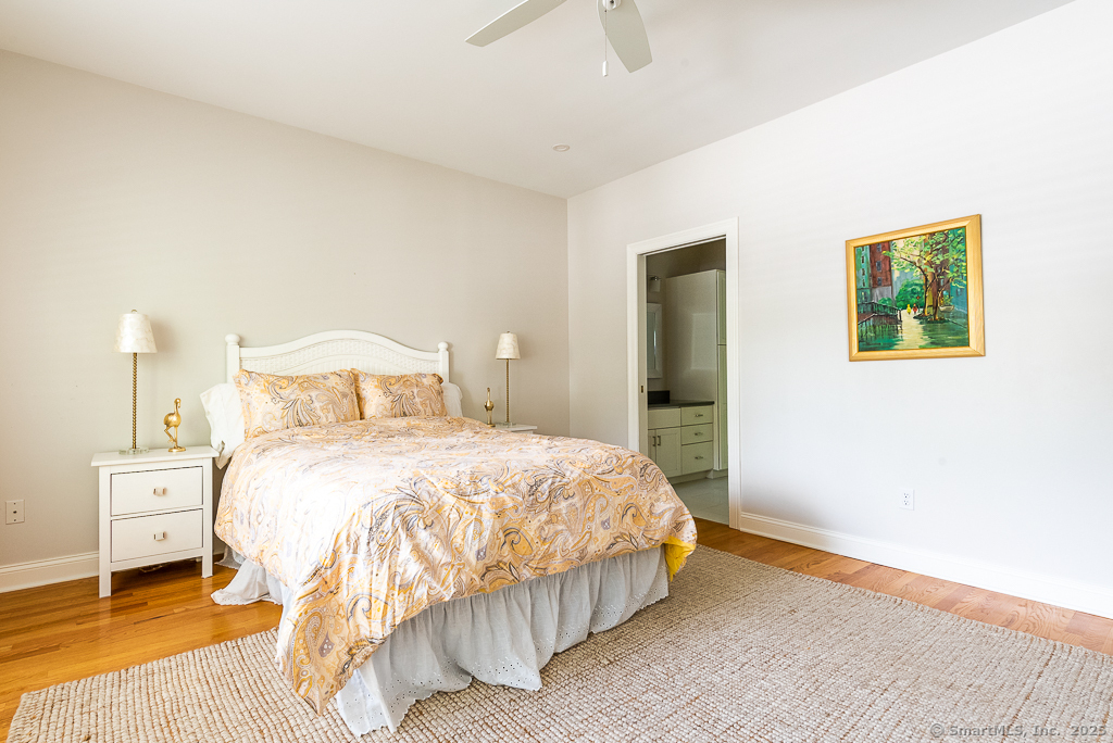 175 Ferry Road, Unit 3 Old Saybrook, CT 06475 - Photo 18 of 37 a bedroom with a bed and a painting on the wall