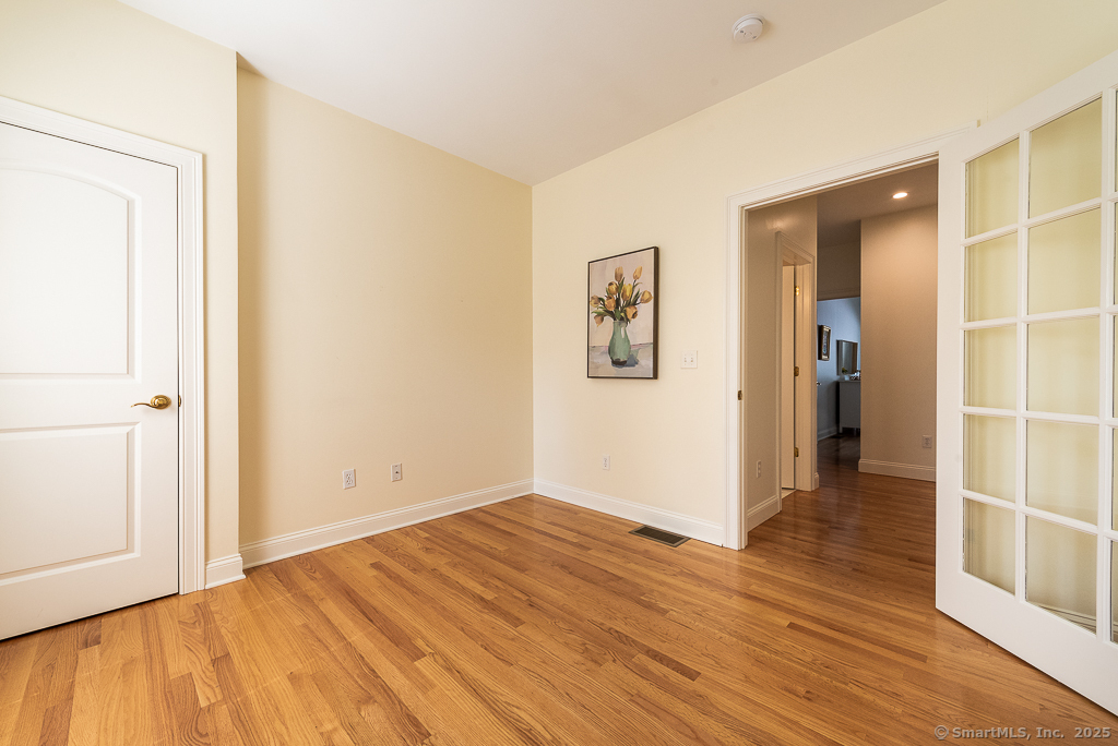 175 Ferry Road, Unit 3 Old Saybrook, CT 06475 - Photo 27 of 37 a view of a room with wooden floor and bathroom
