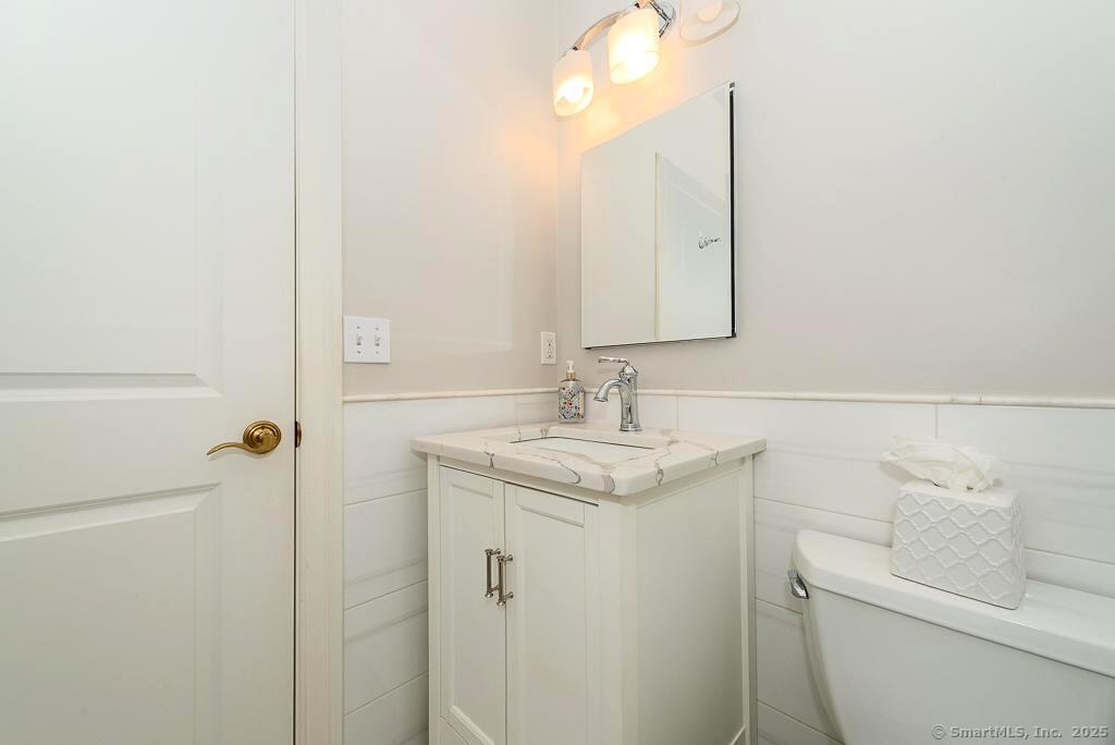 175 Ferry Road, Unit 3 Old Saybrook, CT 06475 - Photo 29 of 37 a bathroom with a granite countertop sink toilet and shower