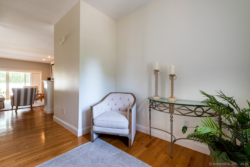 175 Ferry Road, Unit 3 Old Saybrook, CT 06475 - Photo 4 of 37 a view of a hallway with a livingroom and furniture