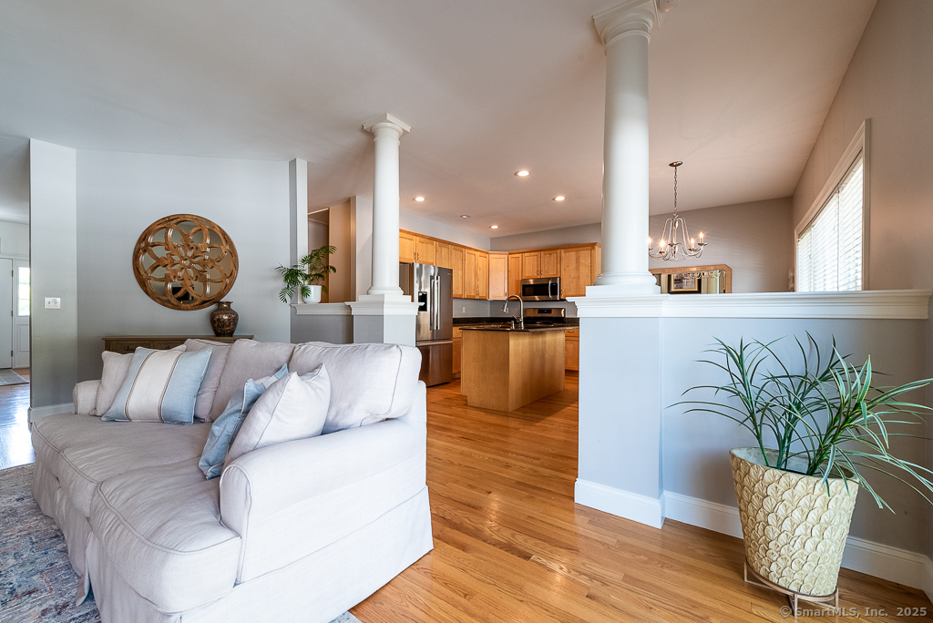 175 Ferry Road, Unit 3 Old Saybrook, CT 06475 - Photo 7 of 37 a living room with furniture and a potted plant