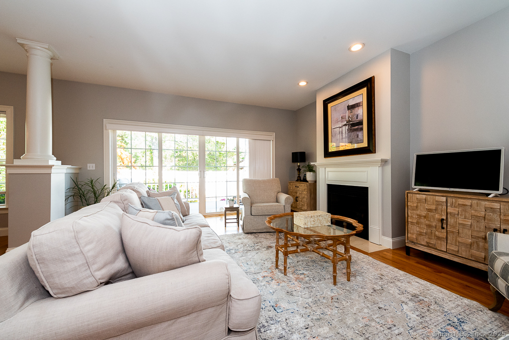 175 Ferry Road, Unit 3 Old Saybrook, CT 06475 - Photo 8 of 37 a living room with furniture a flat screen tv and a fireplace