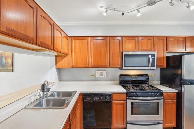 3407 Sandpiper Drive Aurora, IL 60504 - Photo 7 of 20 a kitchen with stainless steel appliances granite countertop a sink stove and refrigerator